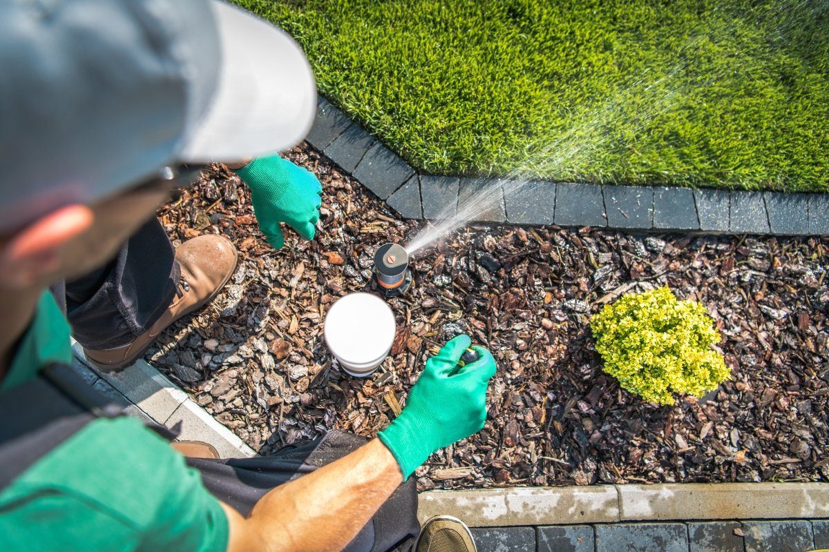 person replacing a sprinkler head